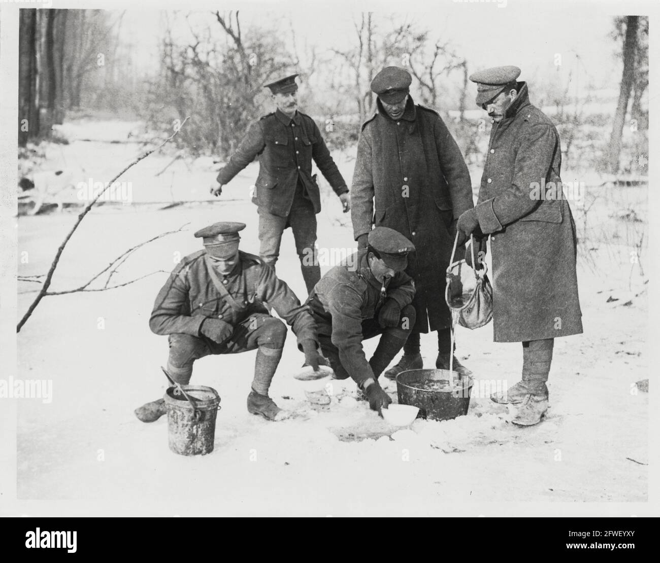 World War One, WWI, Western Front - Men draw water up through a hole in the ice, France Stock Photo