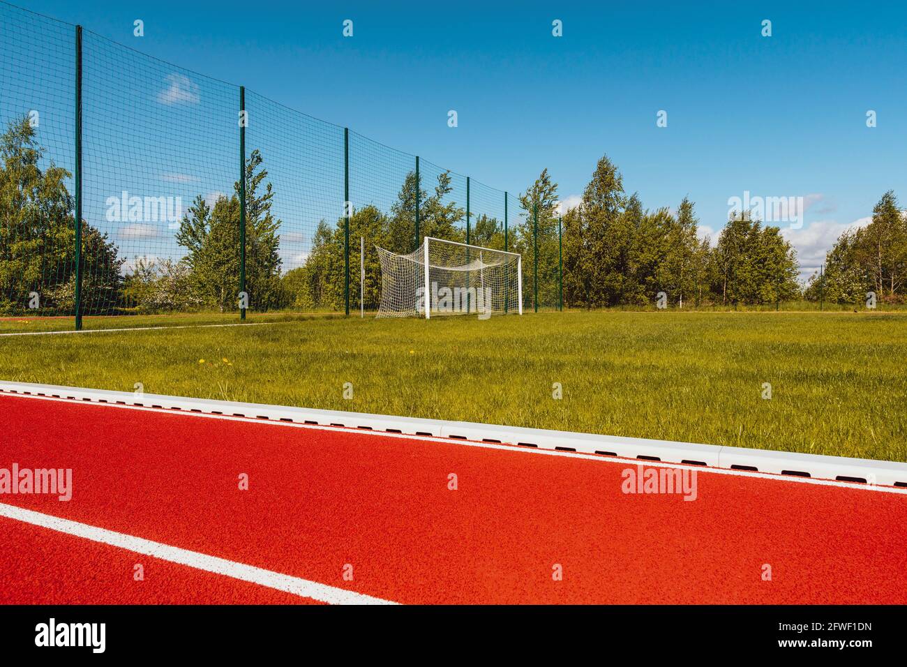 Outdoor running track with behind soccer goals Stock Photo Alamy