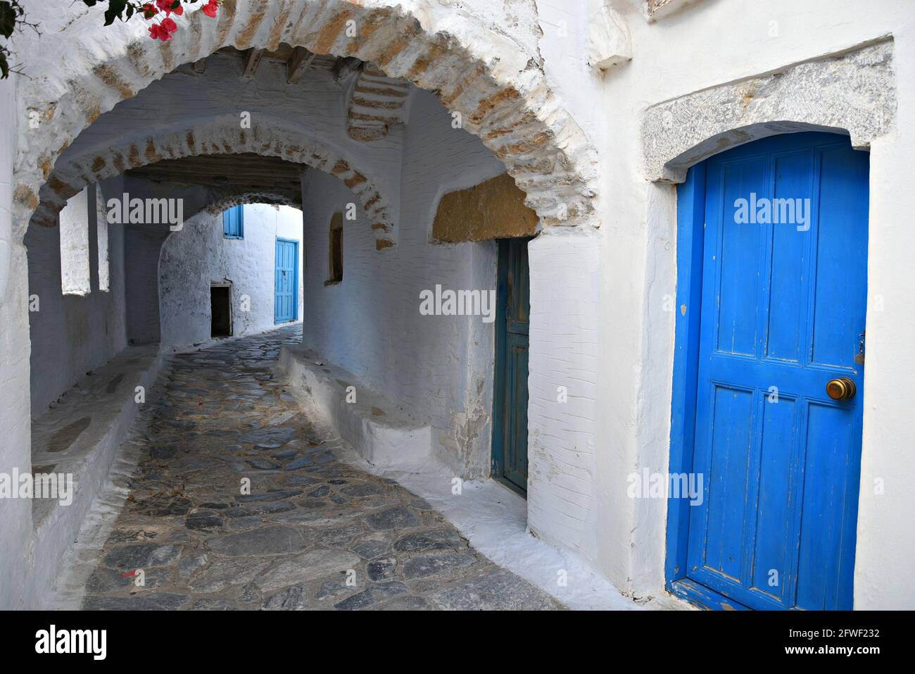 Scenic arched view of picturesque whitewashed houses in Chora the