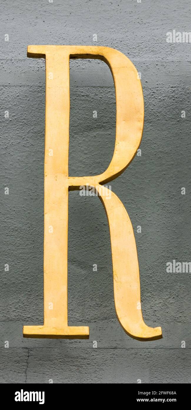 Floating Letter R Golden letter R floating in front of grey house wall Stock Photo - Alamy