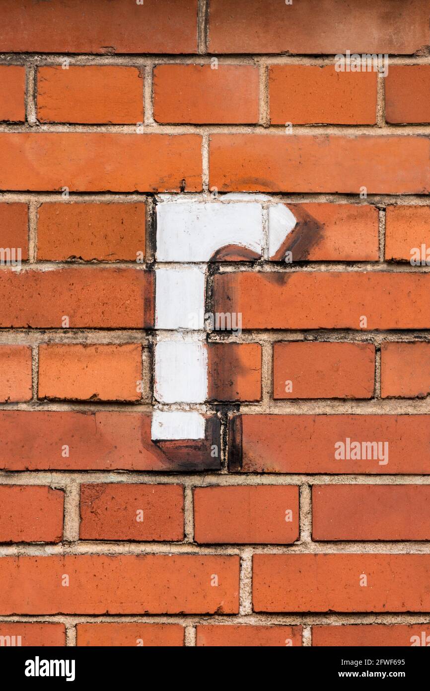A white letter r painted on a red brick wall Stock Photo - Alamy