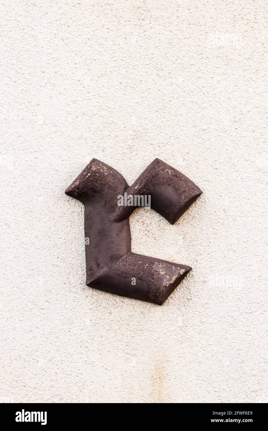 Black letter r in brown colour on light wall Stock Photo - Alamy