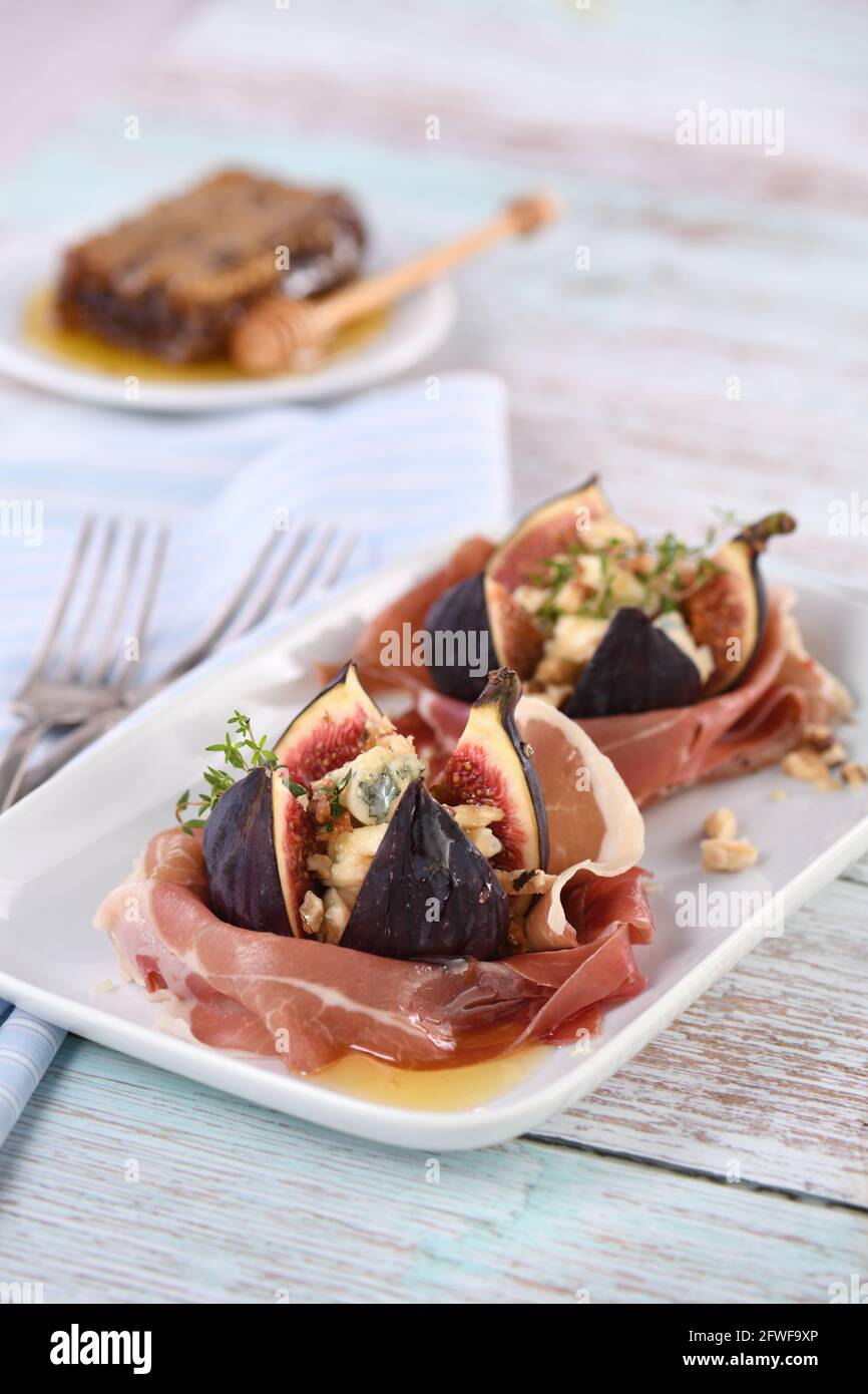 Figs stuffed with blue cheese, wrapped in Parma ham, drizzled with