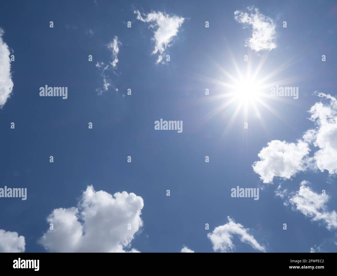 Brillant sun shining in blue sky overhead in southwest Florida USA Stock Photo