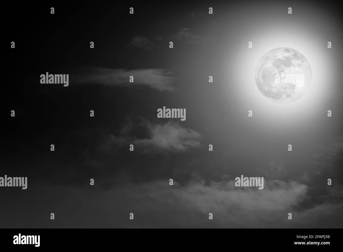 Background of nighttime sky with cloud and full moon with shiny. Natural beauty at night in black and white style. Vintage effect tone. The moon were Stock Photo