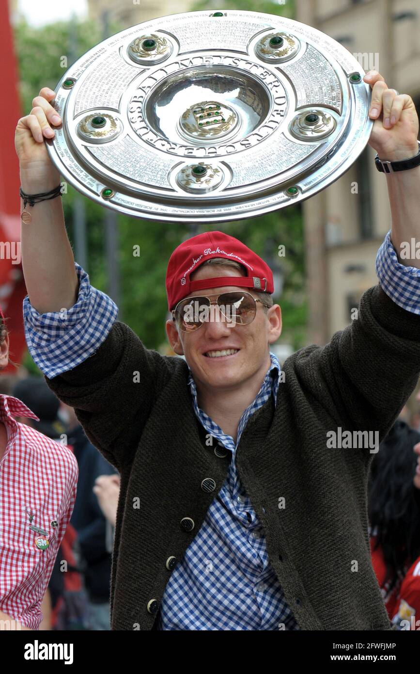 FC Bayern Soccer professional Bastian Schweinsteiger holds up the Trophy celebrating the winning of the 22th German Football Championship Stock Photo