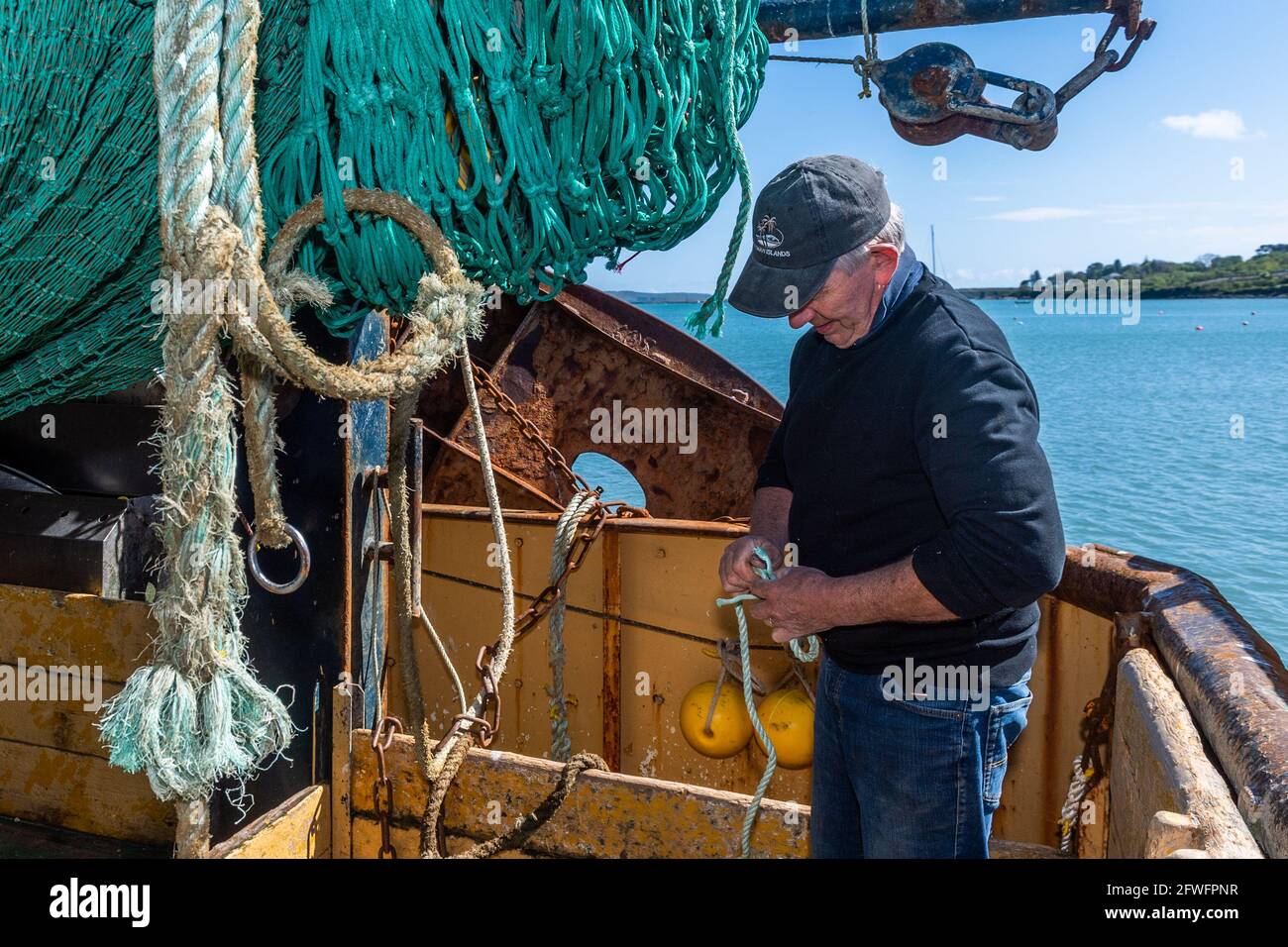 Schull, West Cork, Ireland. 22nd May, 2021. Thomas Sheehan, skipper of the  fishing trawler 'Laetitia', changes one of his fishing nets ahead of a  fishing trip on Monday. The 'Laetitia' is usually