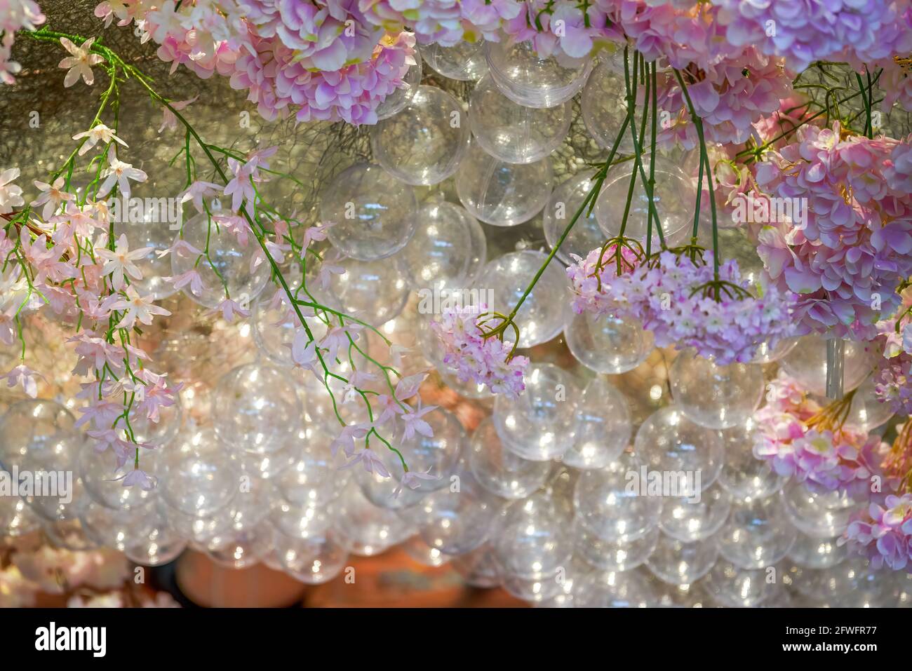 Modern wedding scene with balloon bubbles and purple ceiling flowers Stock Photo