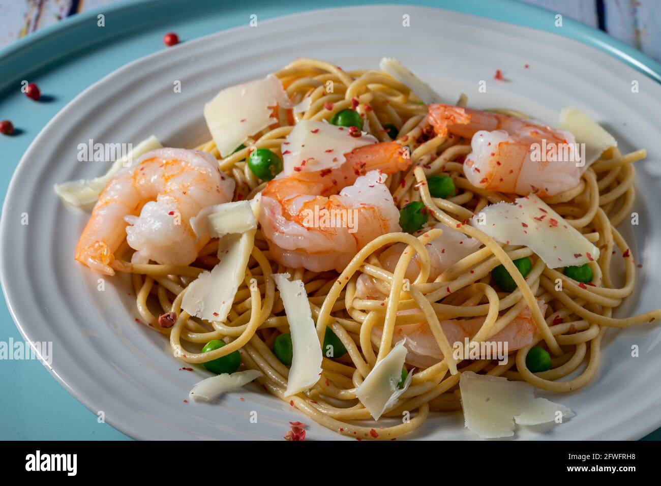 Wheat spaghetti with shrimp and peas. Stock Photo