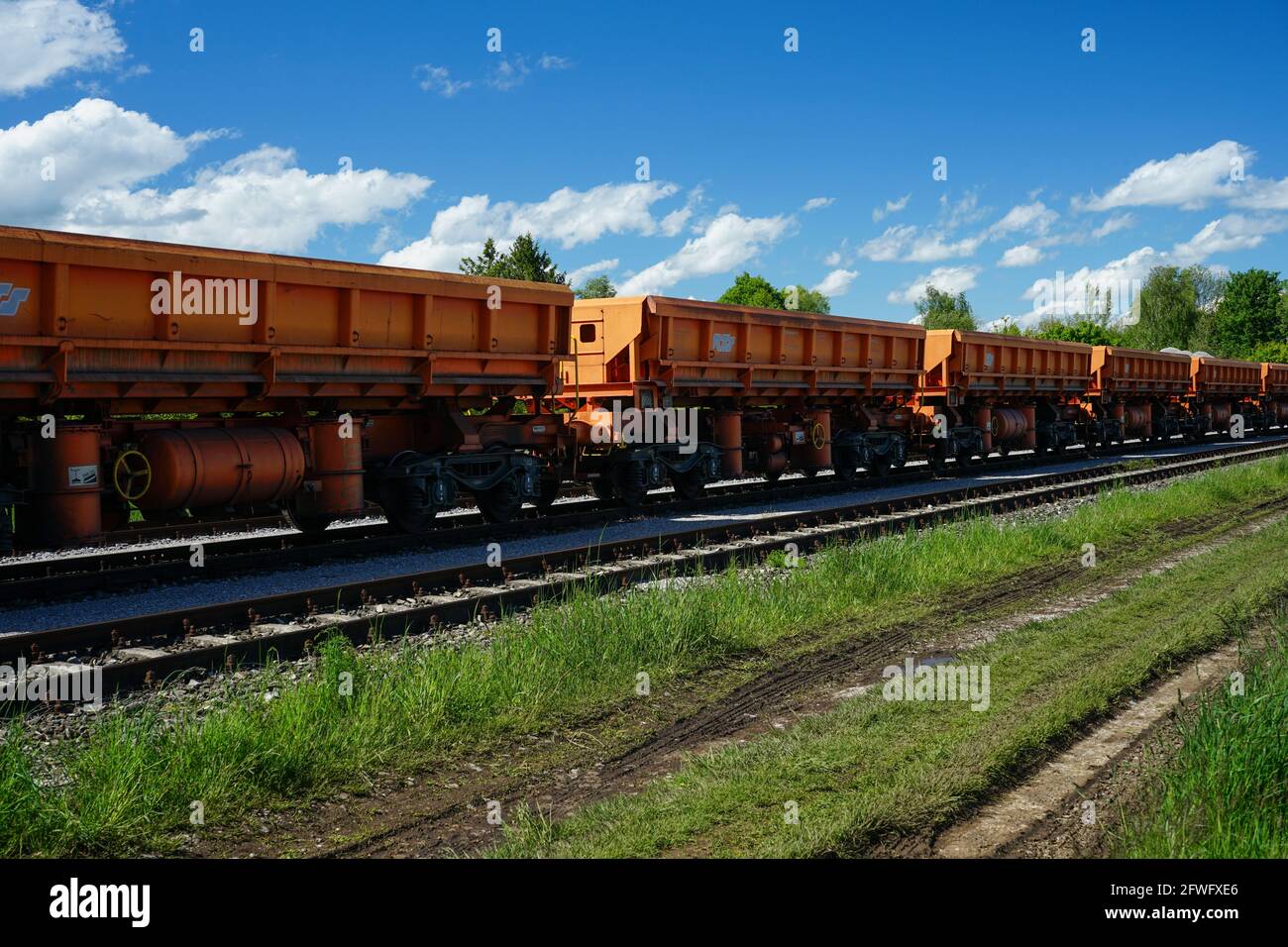 View of a parked cargo train with two locomotives and numerous freight wagons in Harthaus, Germering, Fürstenfeldbruck. Stock Photo