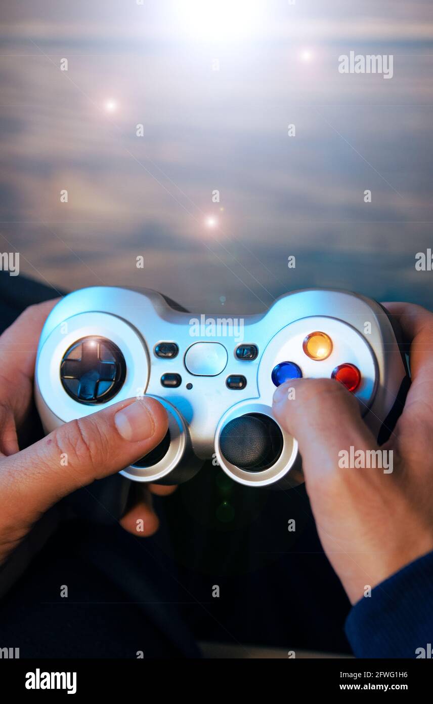 Overhead shot of a man's hands holding a video game controller. Stock Photo