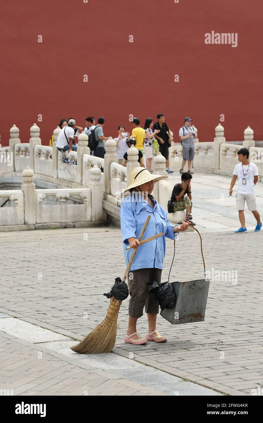 A traditional Chinese cleaning Lady attending to the care of The