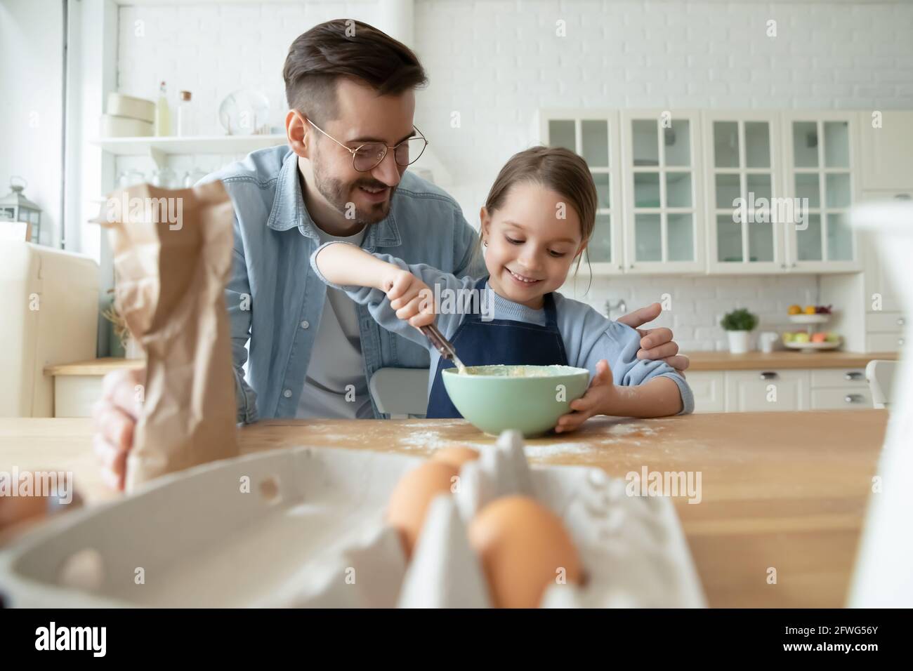 Happy dad bake cookies with small daughter Stock Photo