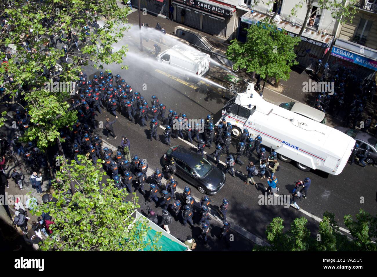Police fire water cannon at Pro-Palestinian rally - Boulevard Barbes, Paris, France Stock Photo