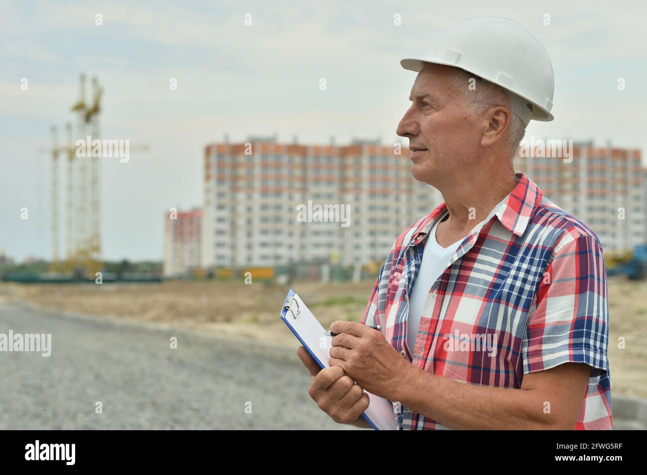 Contruction Paper Man Portrait of senior man in construction site Stock Photo - Alamy