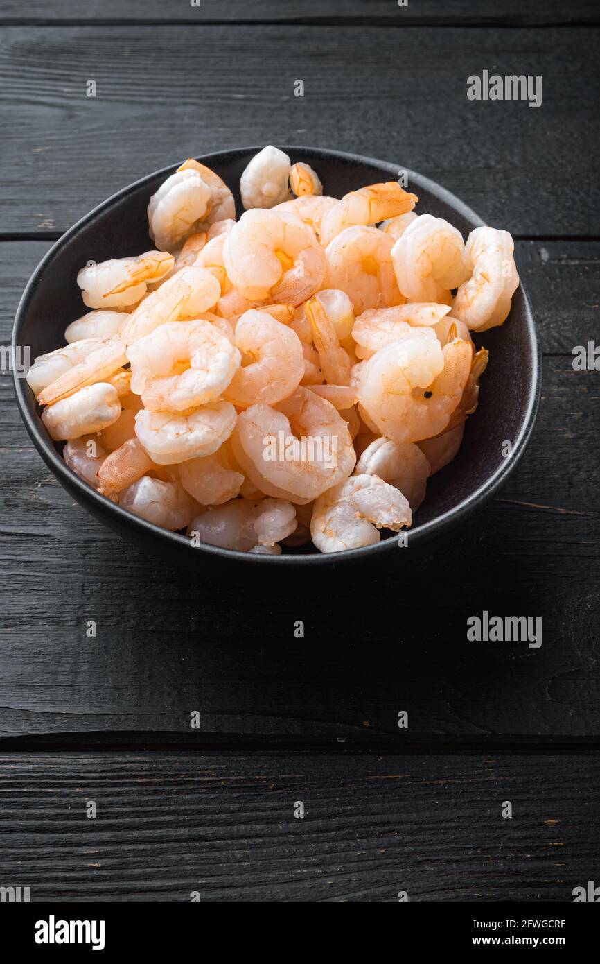 Boiled Prawn Boiled peeled shrimp prawns cooked set, in bowl, on black wooden table ...