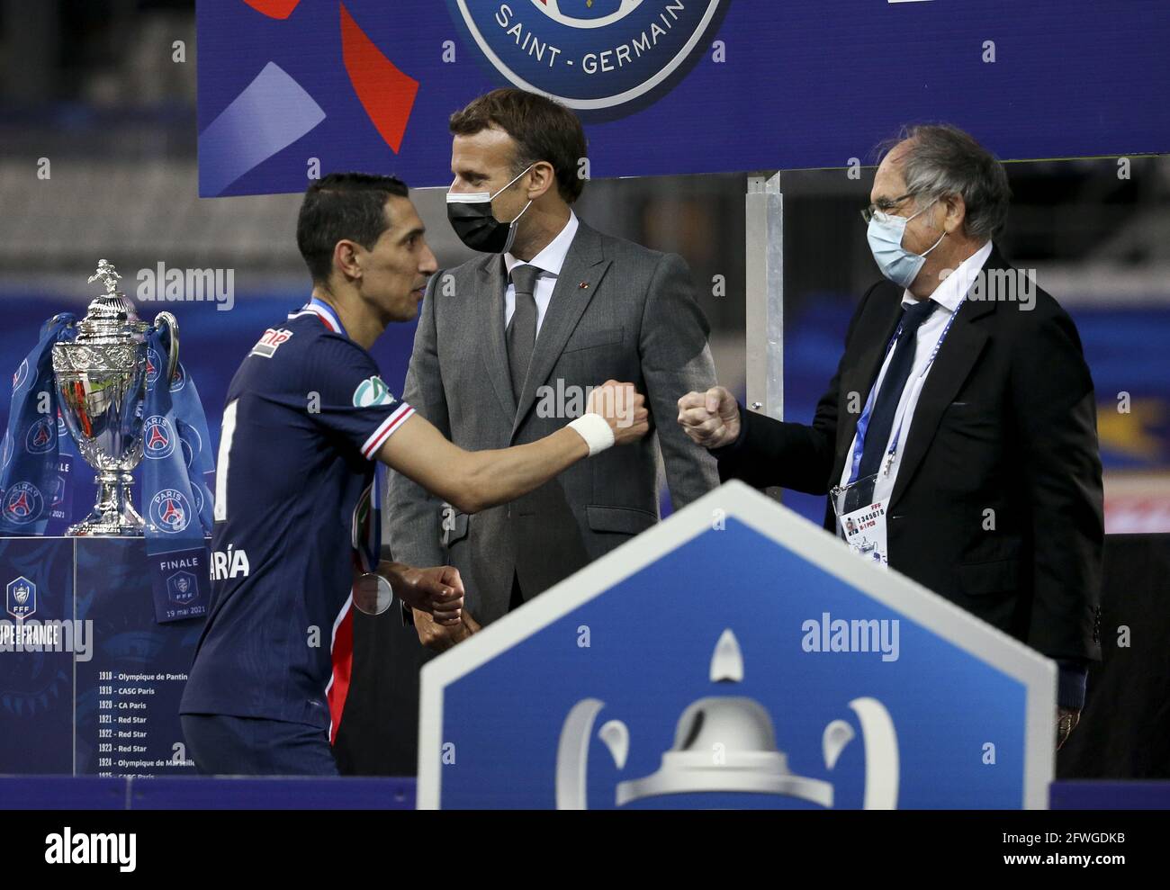 From left, Angel Di Maria of PSG, President of France Emmanuel Macron,  President of French Football Federation FFF Noel Le Graet during the trophy  ceremony following the French Cup Final football match