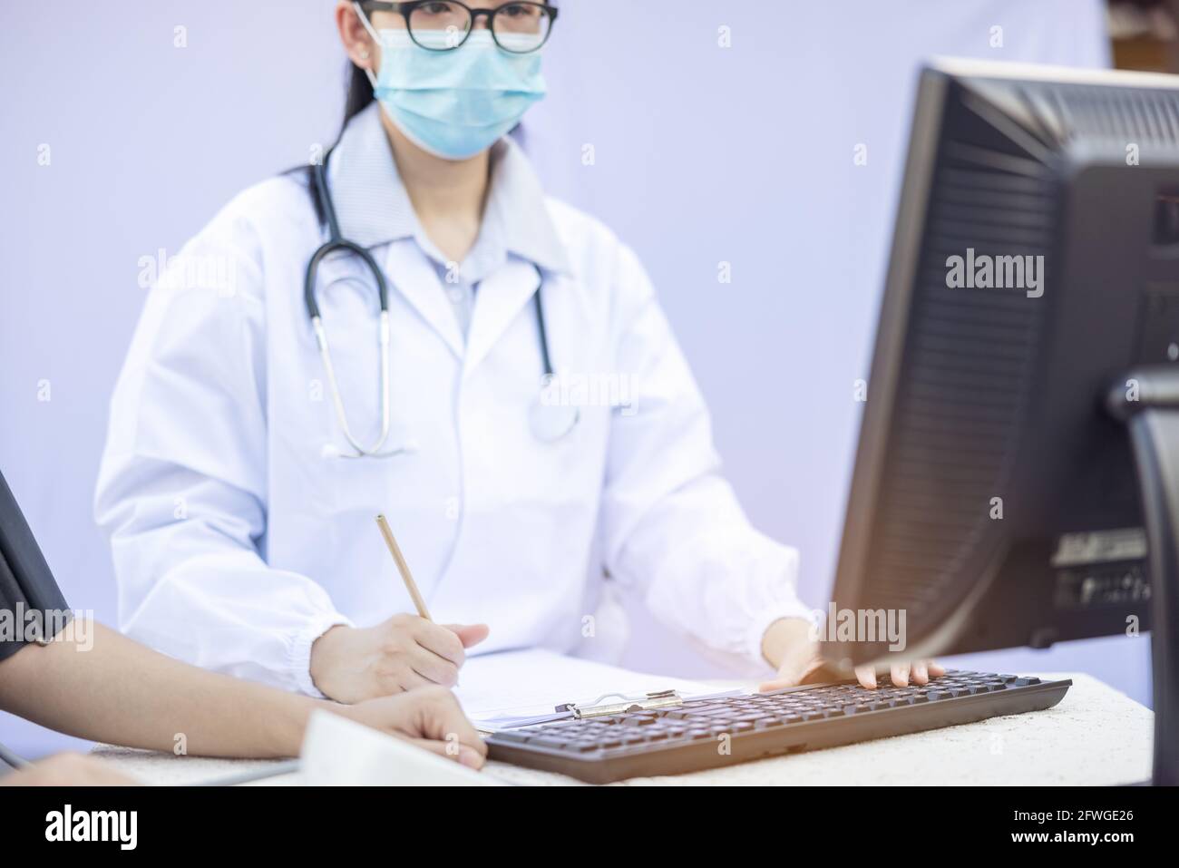 Female Doctor Measuring Blood Pressure Of women patient social service in  local village Thailand. Stock Photo