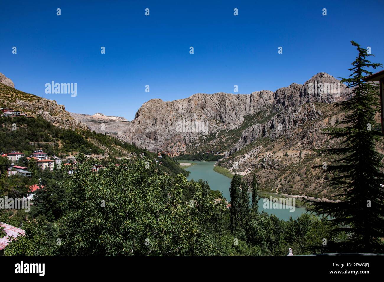 A panoramic photo of a scenery that reflects the beauty of Erzincan. The blue lake in the midst of the mountains under the sky creates a magnificent a Stock Photo