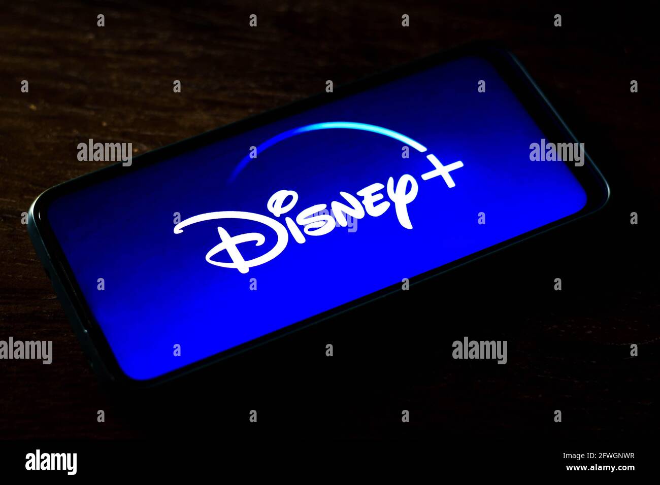 In this photo illustration the Disney + (Plus) logo seen displayed on a smartphone screen. Is an online video streaming subscription service owned and operated by Direct-to-Consumer & International, a subsidiary of The Walt Disney Company. Stock Photo
