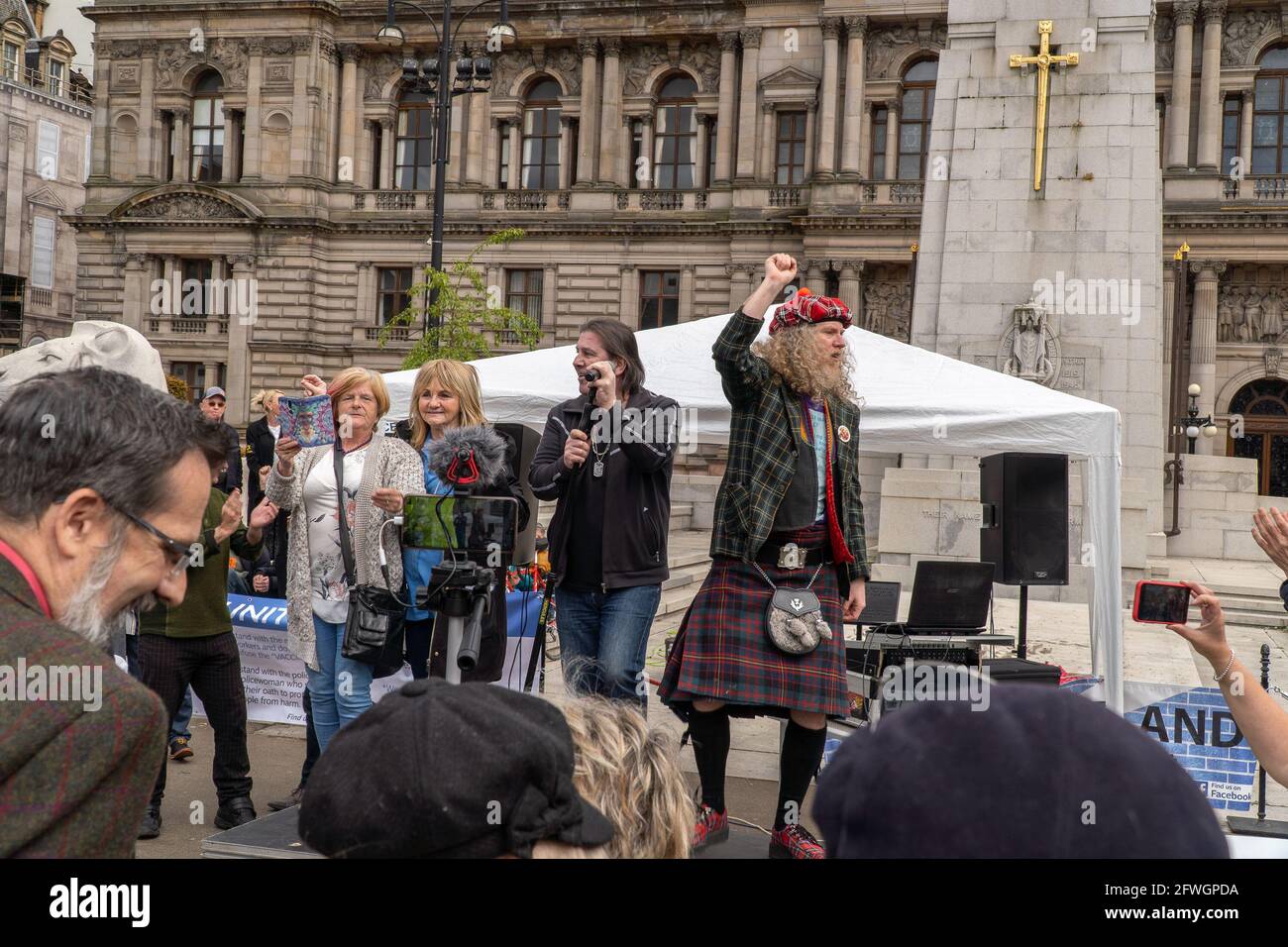 George Square, Glasgow, Scotland, UK, 22nd of May 2021: A large crowd gathers for an anti lockdown protest in front of the council building in George Square, Glasgow city centre, organised by (unite for truth), with key speaker David Scott, (Northern Exposure Correspondent for The UK column), the event had numerous speakers addressing the crowd. They are protesting the ongoing lockdown restrictions which are seen throughout Scotland. The organisers had entertainment, which seen the crowd dancing to the music and hugging each other in excitement. Credit: Barry Nixon/Alamy Live News/Alamy Live N Stock Photo