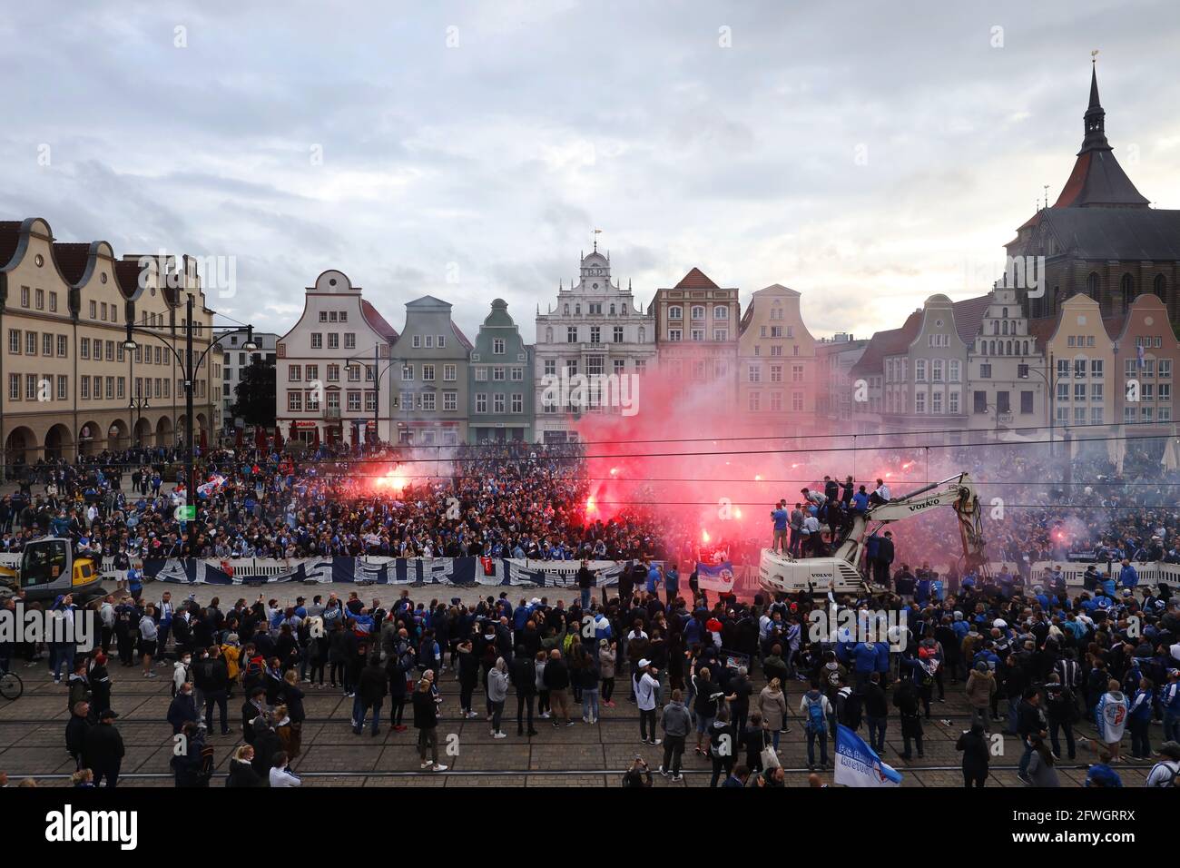Rostock, Germany. 27th Apr, 2021. Supporters of FC Hansa Rostock celebrate  the promotion of FC Hansa