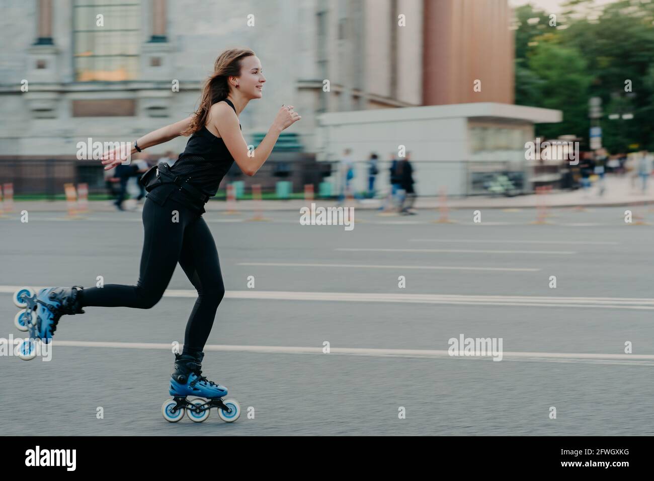 Active dark haired woman in good physical shape enjoys extreme sport ...