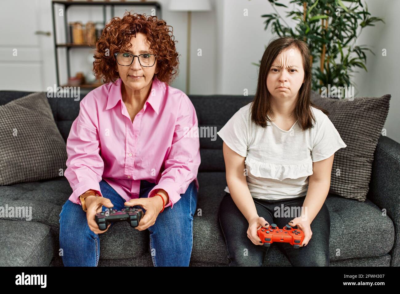 Mature mother and down syndrome daughter at home playing video games Stock  Photo - Alamy