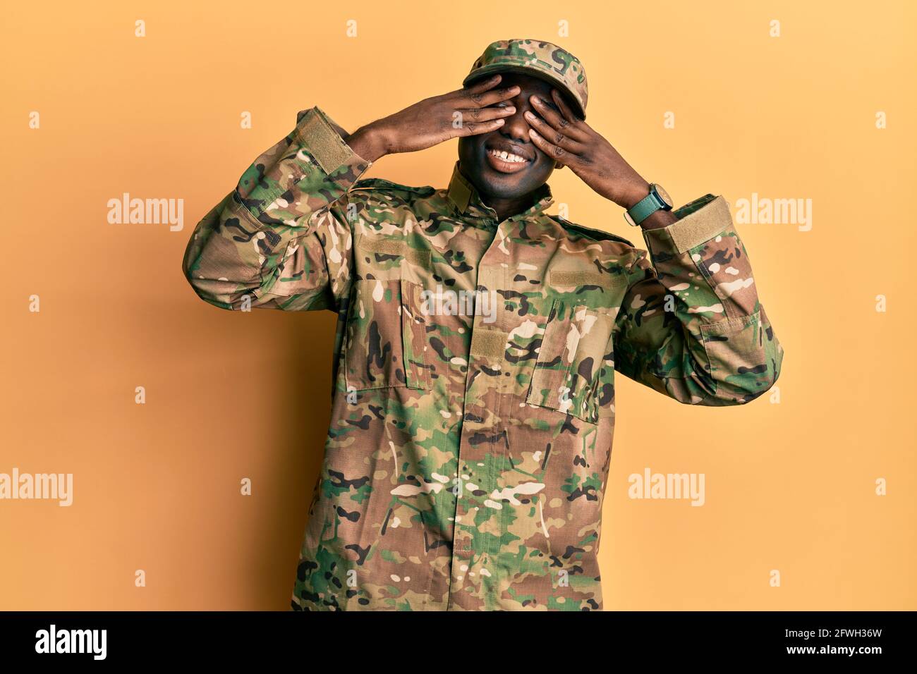 Young african american man wearing army uniform covering eyes with ...