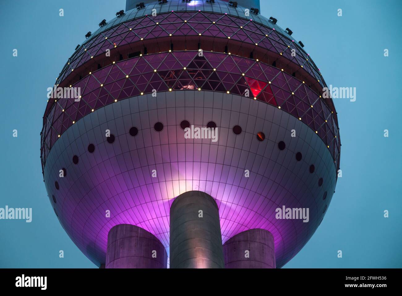 Detail of the Oriental Pearl TV Tower, illuminated in purple lighting during the blue hour, Shanghai, PRC Stock Photo