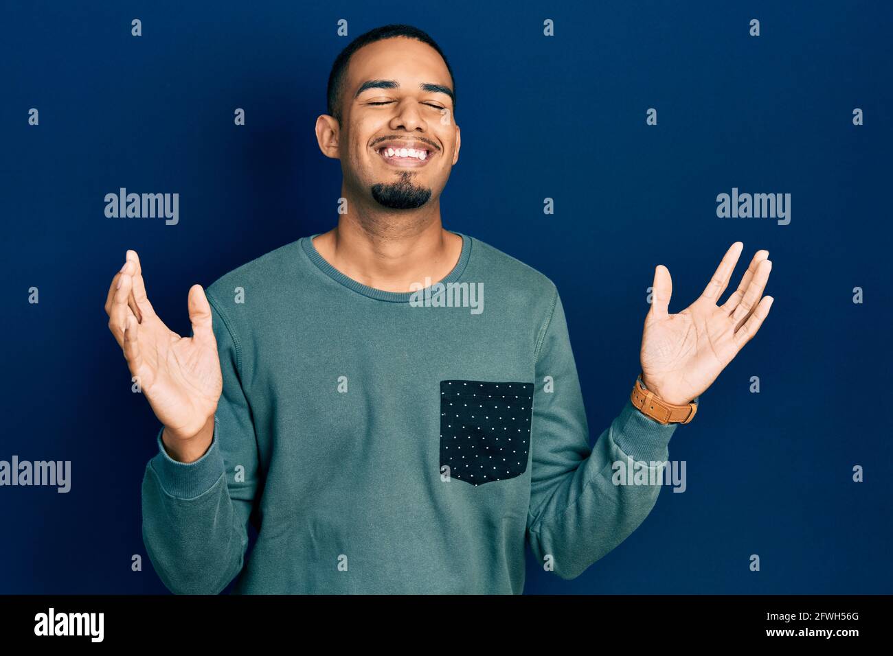 Young african american man wearing casual clothes celebrating mad and ...