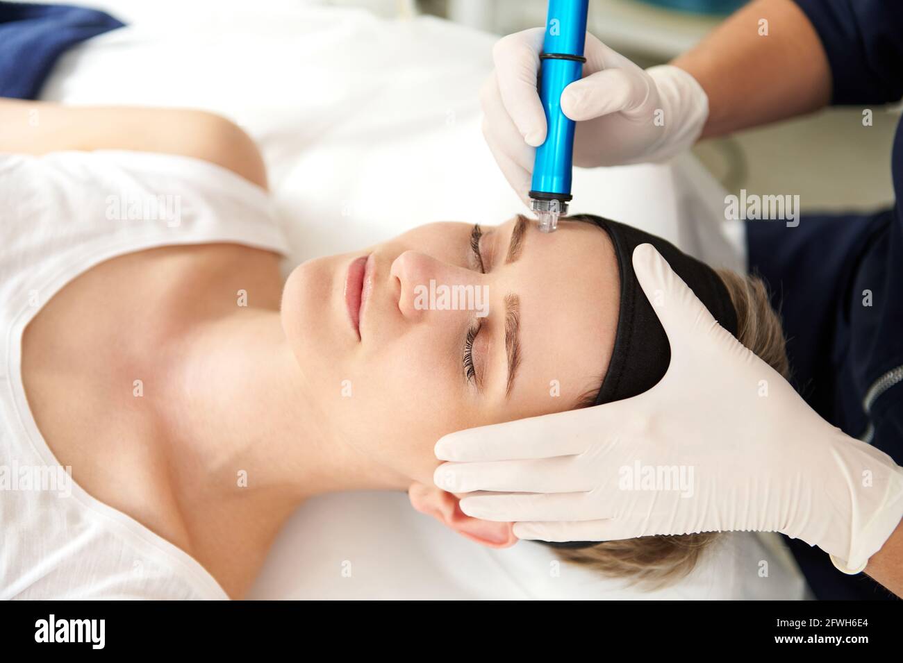 Woman getting facial hydro microdermabrasion peeling treatment at spa center. Hydra Vacuum