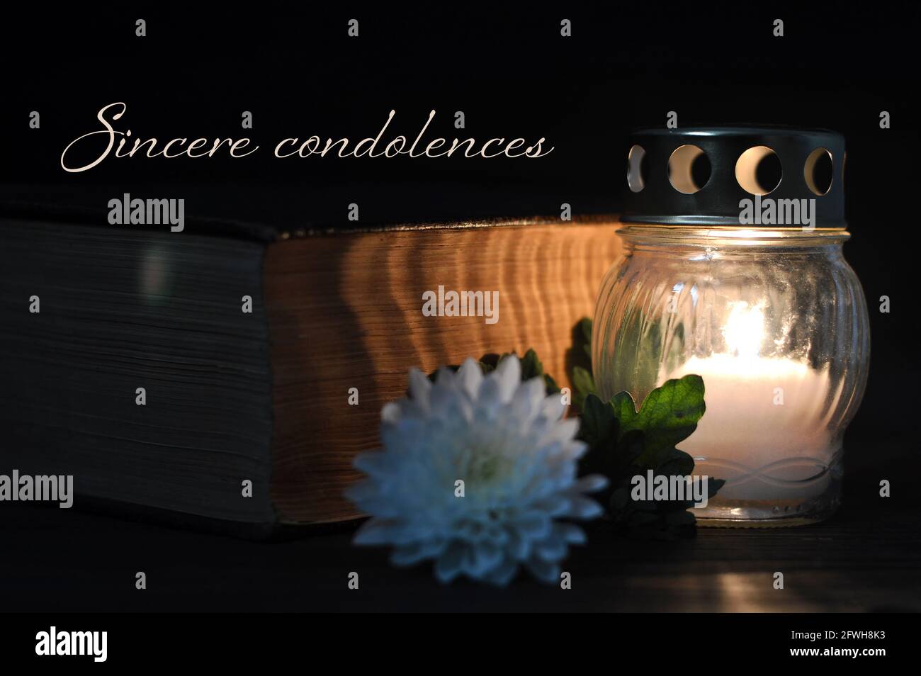 Condolence card with  white burning candle and flower Stock Photo