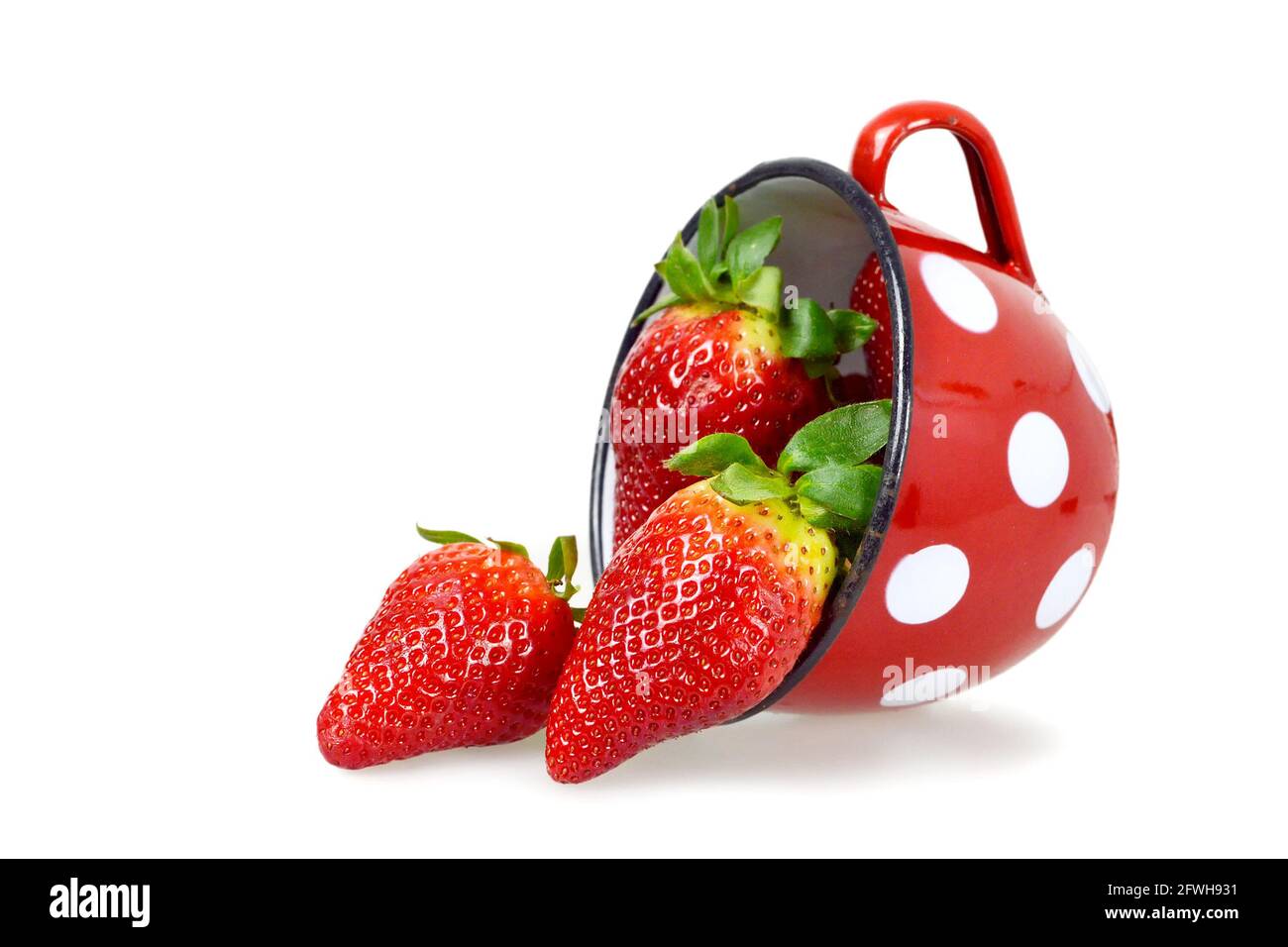Strawberries in the old mug isolated on white background Stock Photo