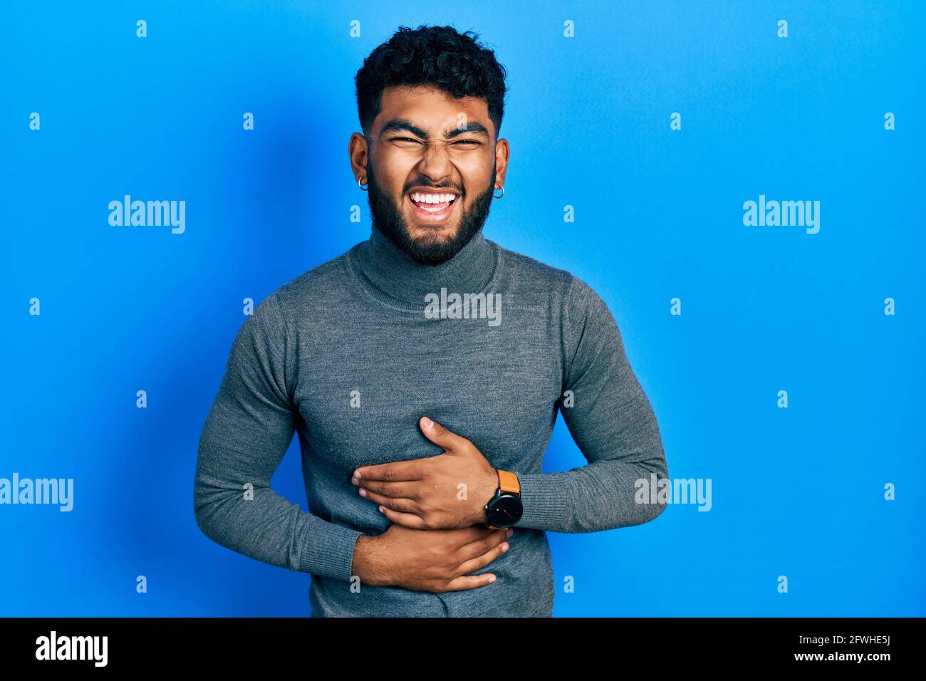 Arab man with beard wearing turtleneck 