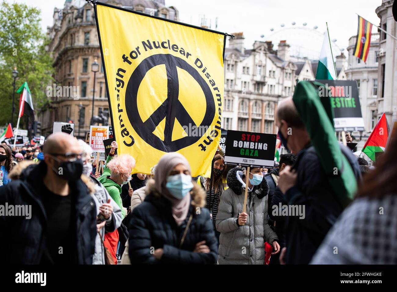 Protesters hold placards and Palestinian flags during the demonstration.Palestinian Citizens are being subject to violent armed mobs, attempting to drive them from their homes. The violence is part of Israel's regime of institutionalised racist discrimination against the Palestinian people, amounting to the crime of apartheid. The UK Government is expected to take action, which includes implementing sanctions, military embargo to cut the supply of deadly weapons to Israel, and banning the import of goods from Israel's illegal settlements. Stock Photo