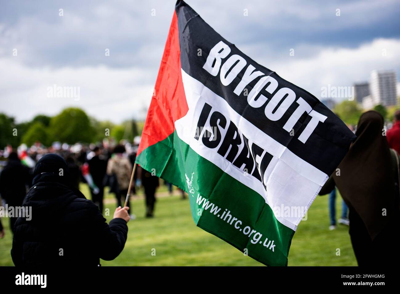 A protester holds a Palestinian flag during the demonstration.Palestinian Citizens are being subject to violent armed mobs, attempting to drive them from their homes. The violence is part of Israel's regime of institutionalised racist discrimination against the Palestinian people, amounting to the crime of apartheid. The UK Government is expected to take action, which includes implementing sanctions, military embargo to cut the supply of deadly weapons to Israel, and banning the import of goods from Israel's illegal settlements. Stock Photo