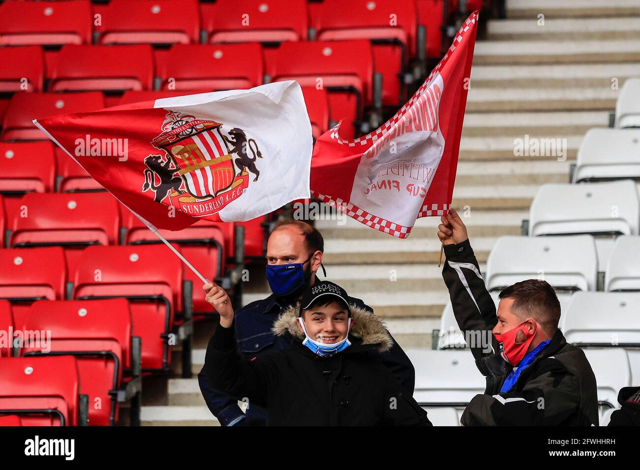 Two Sunderland fans wave their flags as they enjoy returning to the Stadium of Light after 14 months away due to Covid-19 restrictions Stock Photo