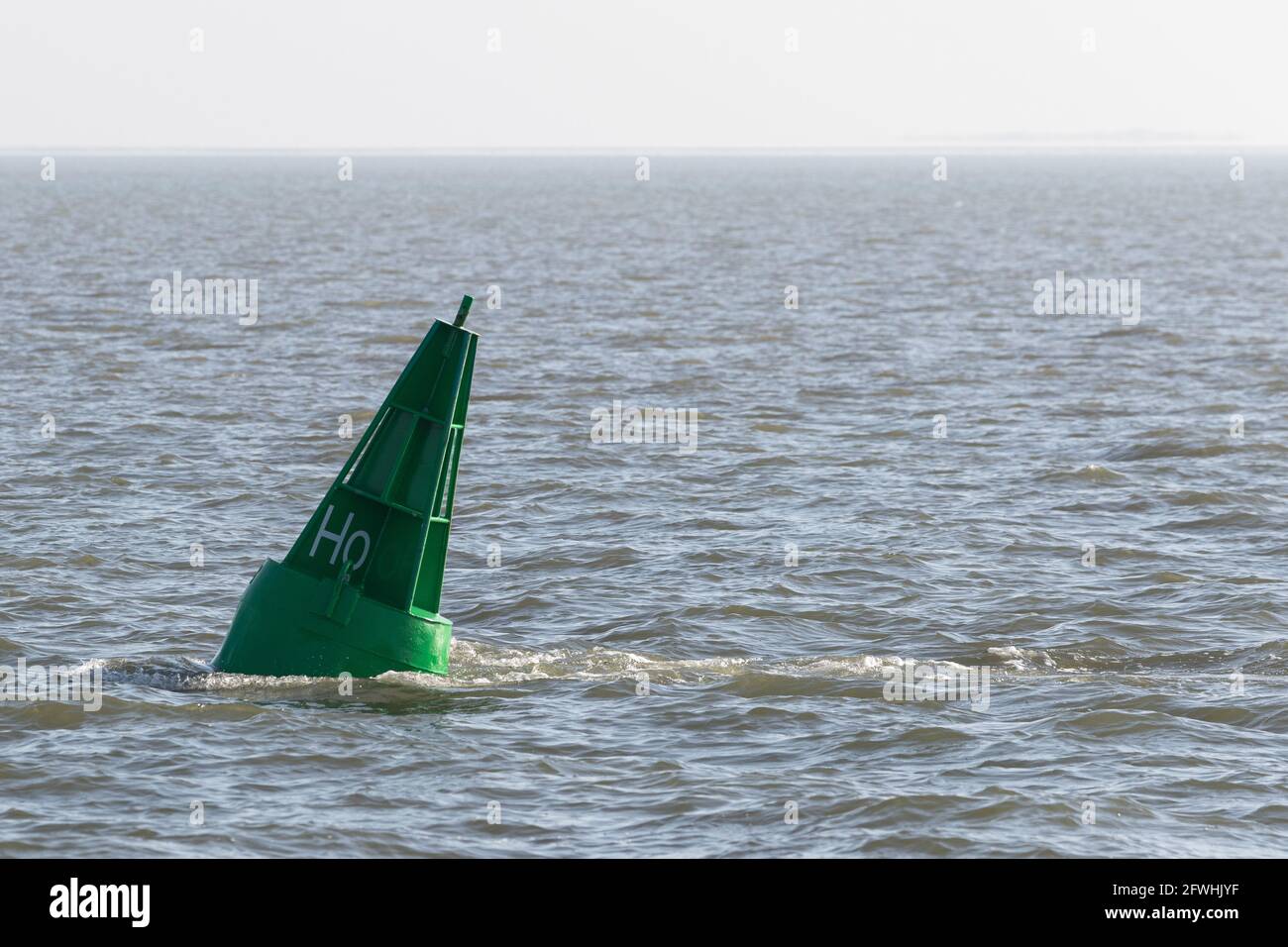 Green conical buoy swims in the North Sea Stock Photo - Alamy