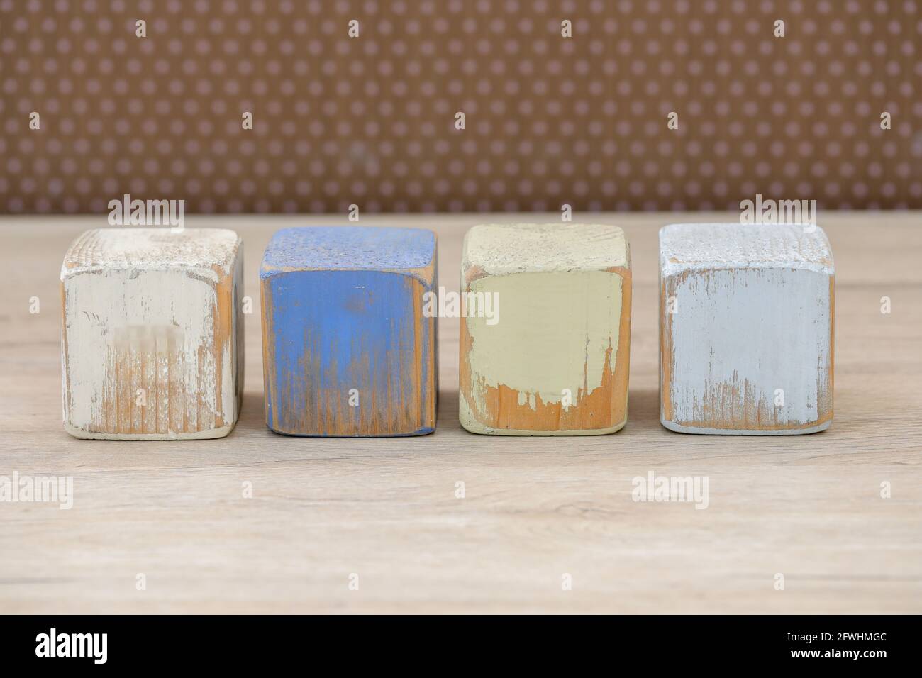 Wooden blocks on a wooden surface and a brown background. Stock Photo