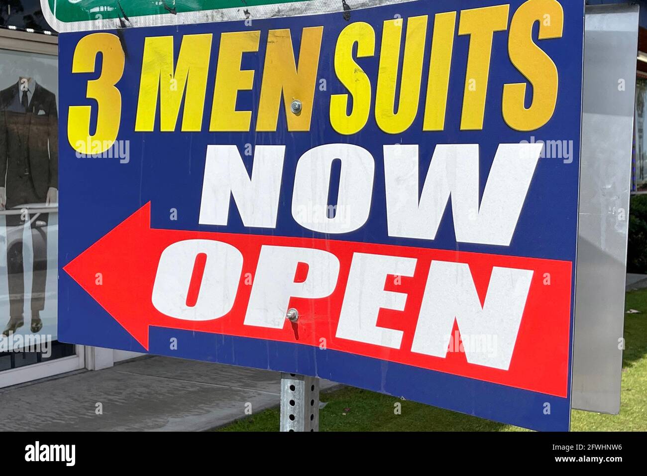 A 'Now Open' sign at 3 Men's Suits, Saturday, May 22, 2021, in Montebello, Calif. Stock Photo