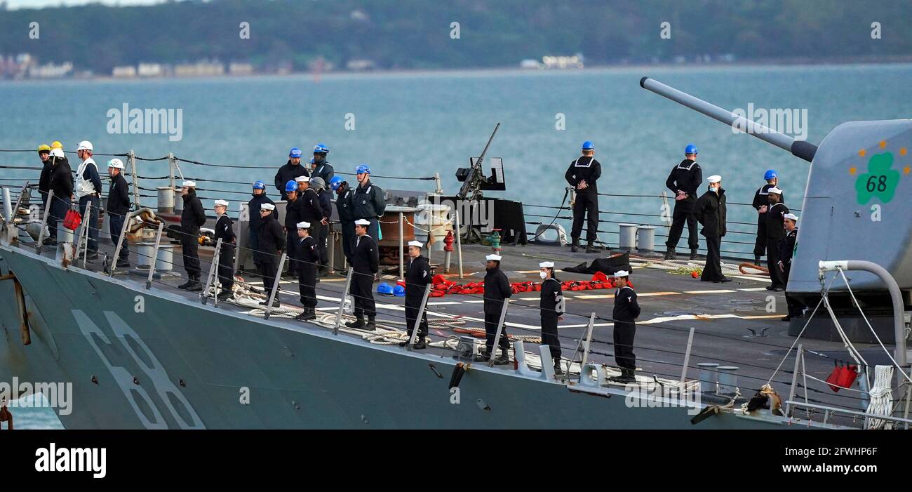Ships company aboard USS The Sullivans (DDG-68), an Arleigh Burke-class (Flight I) Aegis guided missile destroyer, as she departs HM Naval Base, Portsmouth, prior to HMS Queen Elizabeth leaving, heralding the start of the carrier's maiden deployment to lead the UK Carrier Strike Group on a 28-week operational deployment travelling over 26,000 nautical miles from the Mediterranean to the Philippine Sea. Picture date: Saturday May 22, 2021. Stock Photo