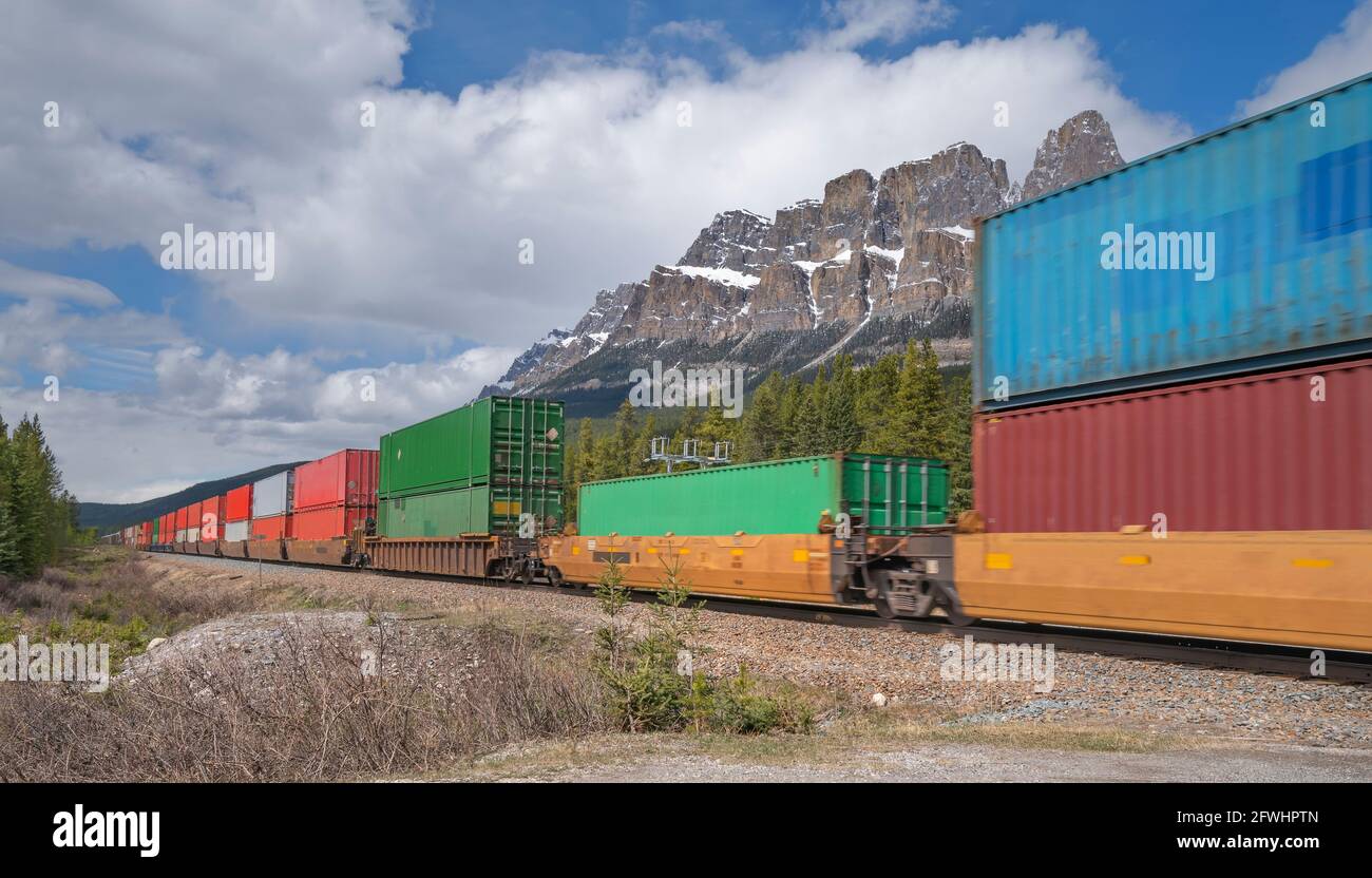 Moving freight train at Castle Mountain in Banff National Park, Alberta, Canada Stock Photo