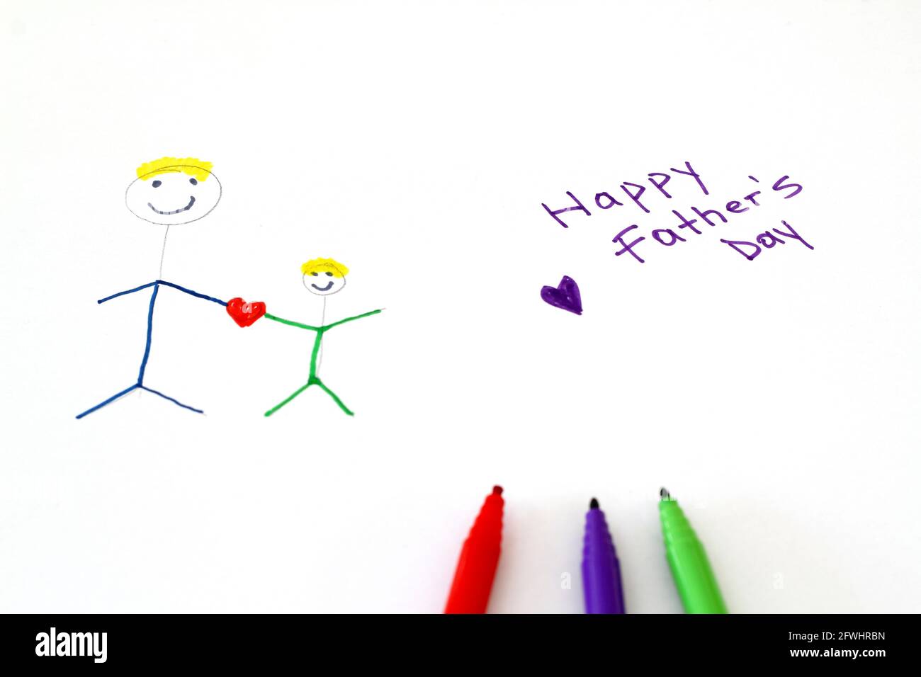kid-s-happy-fathers-day-drawing-and-color-pencils-over-white-stock