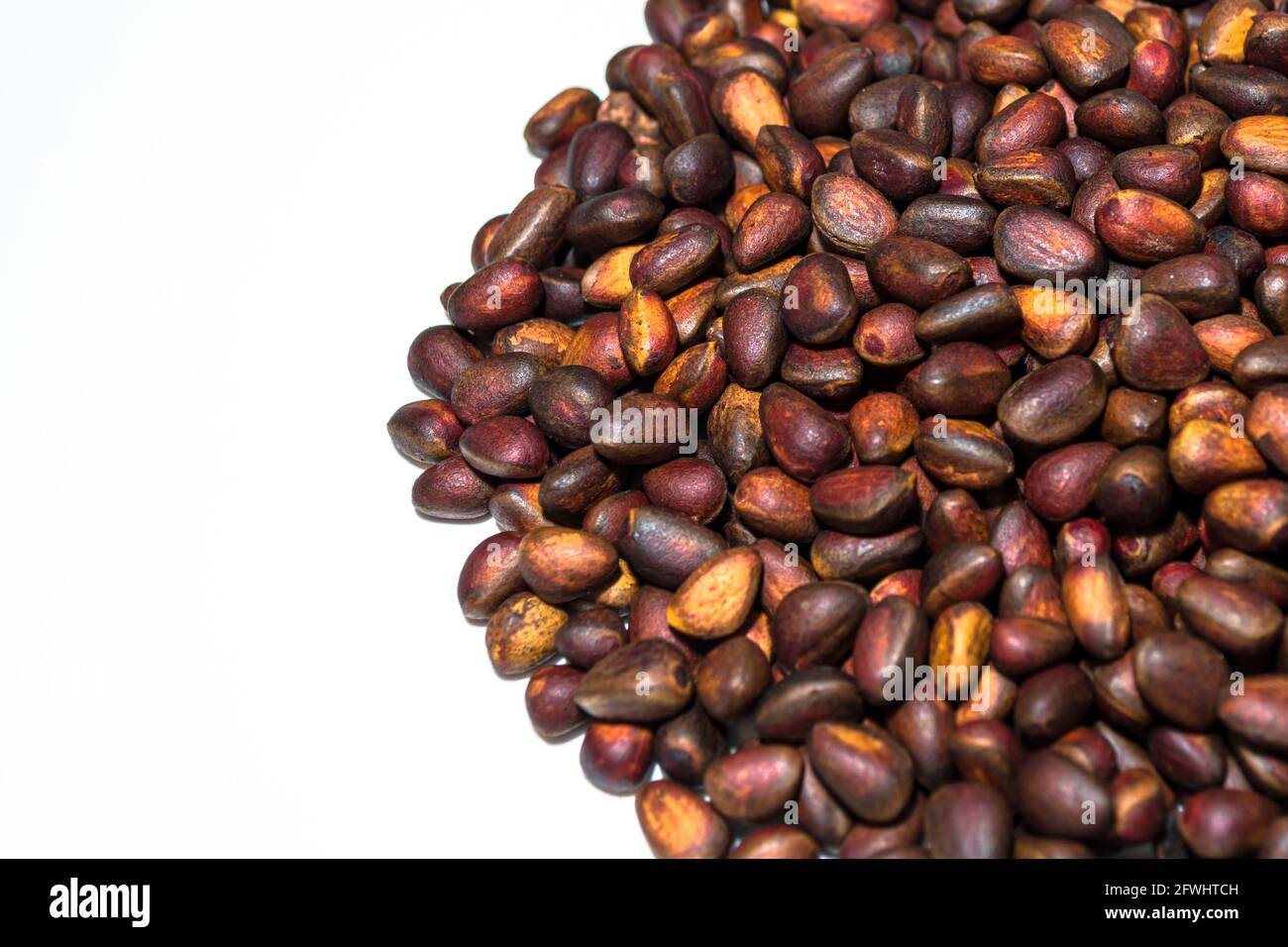 ripe pine nuts scattered on a white background Stock Photo