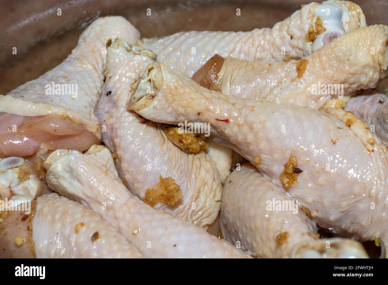 Marinated raw chicken drumsticks for barbecue in a large bowl Stock Photo Alamy