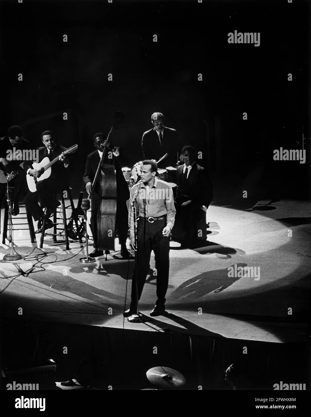 19 May 1962 Singer, Harry Belafonte (center), and an unidentified band perform at a Democratic Party fund-raising dinner and birthday salute to President John F. Kennedy at Madison Square Garden in New York City, New York.  Please credit 'Cecil Stoughton. White House Photographs. John F. Kennedy Presidential Library and Museum, Boston.' Stock Photo