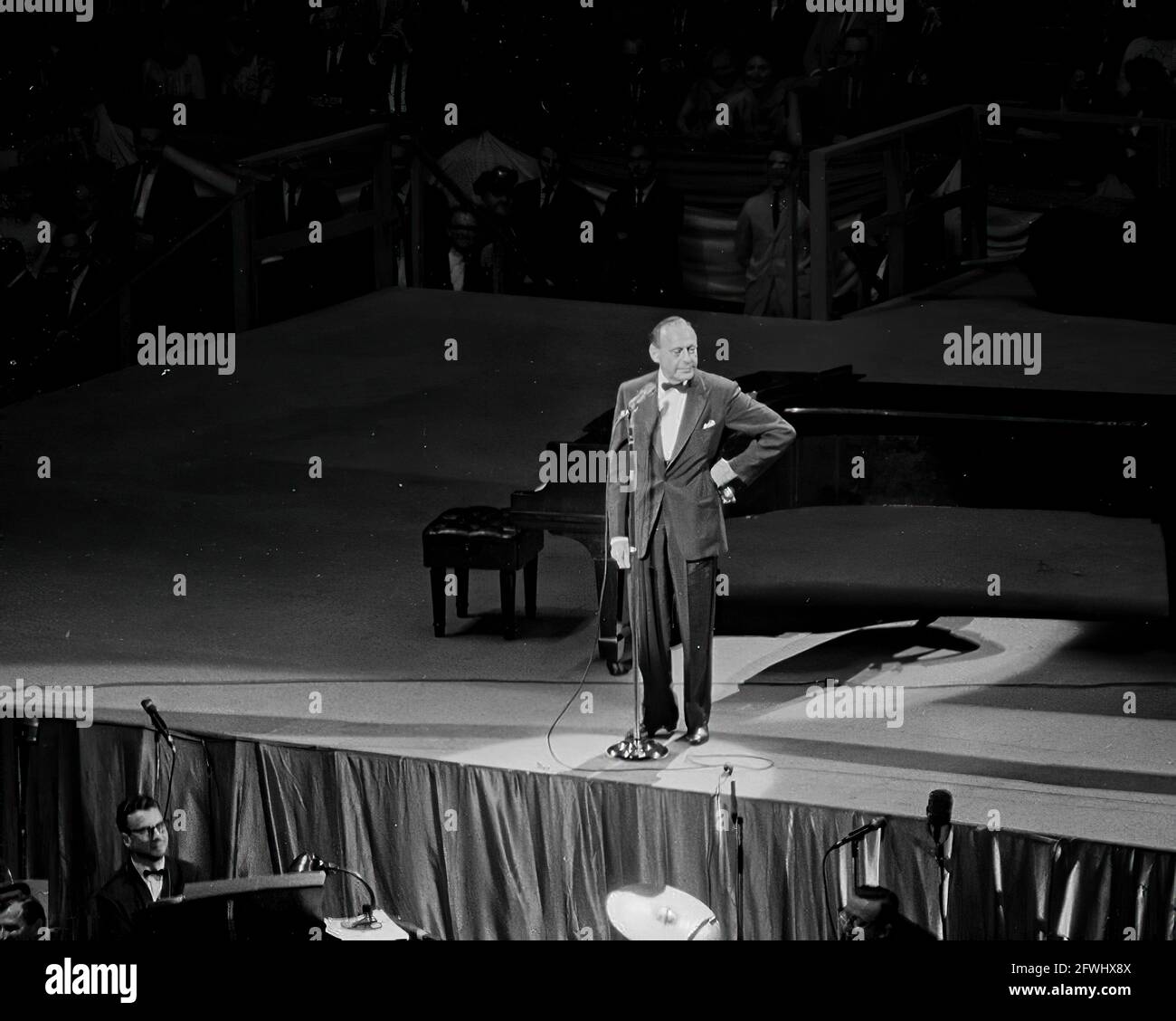 Comedian, Jack Benny, performs at a Democratic Party fund-raising dinner and birthday salute to President John F. Kennedy at Madison Square Garden in New York City, New York. Stock Photo