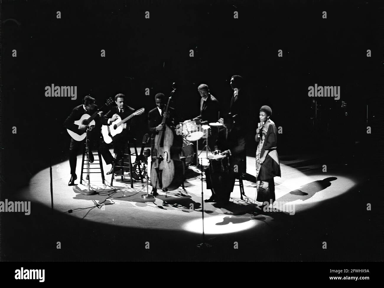 Singer, Miriam Makeba (far right), and an unidentified band perform at a Democratic Party fund-raising dinner and birthday salute to President John F. Kennedy at Madison Square Garden in New York City, New York. Stock Photo