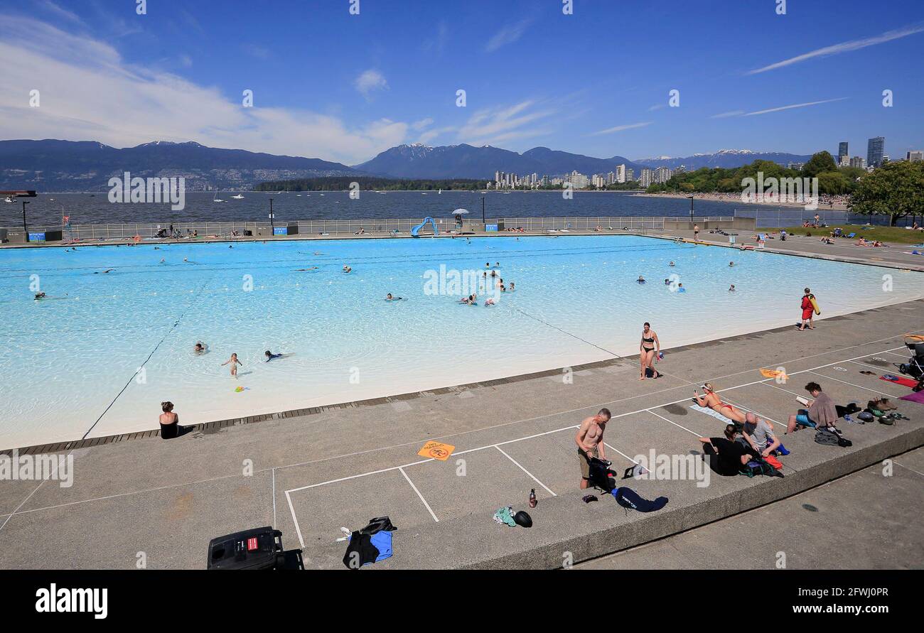Vancouver, Canada. 22nd May, 2021. People go swimming on the first day of re-opening at the Kitsilano outdoor pool in Vancouver, British Columbia, Canada, May 22, 2021. Three of Vancouver's outdoor pools reopened Saturday. Due to the COVID-19 registration in place, anyone who wants to take a dip will have to register in advance due to pandemic-related restrictions on capacity. Credit: Liang Sen/Xinhua/Alamy Live News Stock Photo